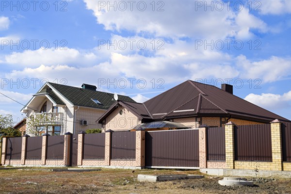 Decorative metal on the roof of a brick house. Atyrau, Kazakhstan