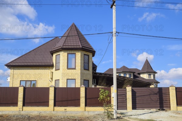 Decorative metal on the roof of a brick house. Atyrau, Kazakhstan