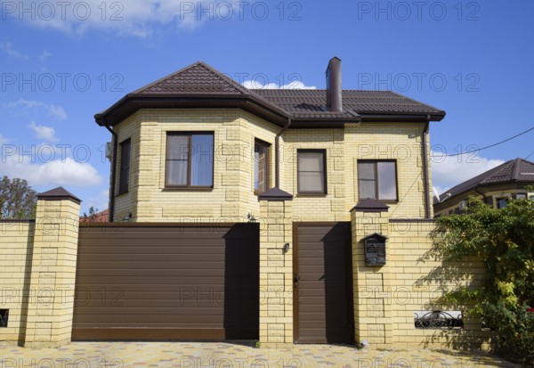 Decorative metal on the roof of a brick house. Atyrau, Kazakhstan