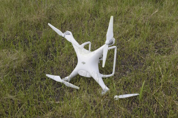The crashed drone. Dirty and in the juice of the grass is a quadrocopter. Atyrau, Kazakhstan