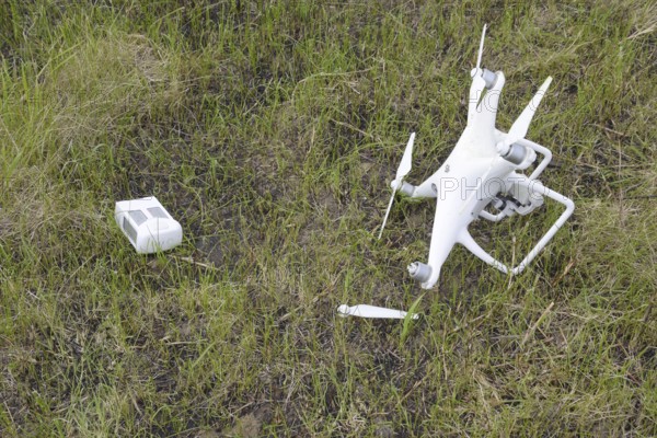 The crashed drone. Dirty and in the juice of the grass is a quadrocopter. Atyrau, Kazakhstan