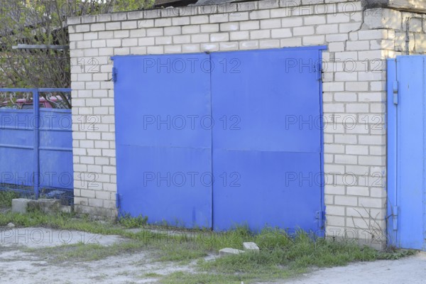 Garage with blue iron gates. Atyrau, Kazakhstan
