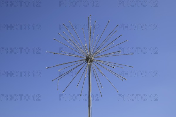 Street lamp in the form of fireworks. Garlands on a steel frame in the shape of a ball fireworks. Atyrau, Kazakhstan