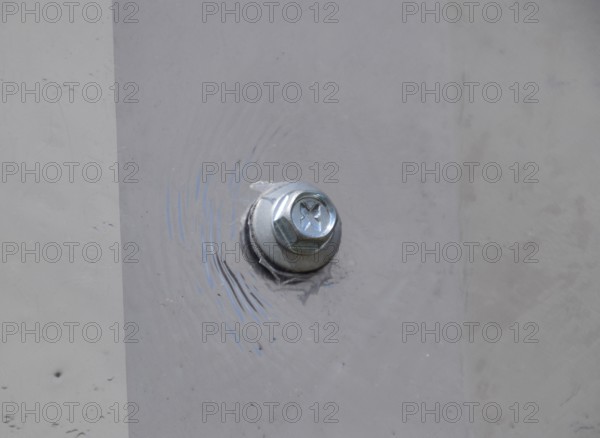 Screw screwed into plexiglas. Atyrau, Kazakhstan