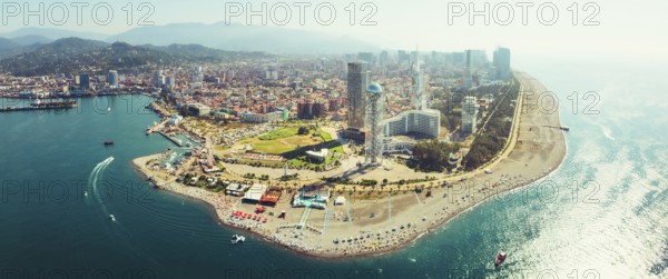 Aerial panoramic view Batumi cityscape with beach and promenade attractions, tourist in sunny summer day. Popular Georgia black sea coastline city holiday destination
