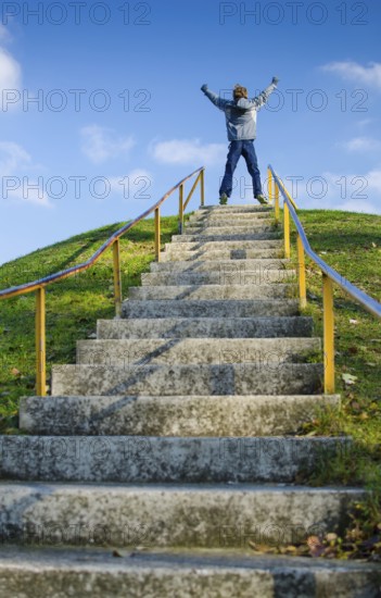 Young Boy On Top Of Outdoor Stairs On Hill Celebrates Success, Vienna, Austria