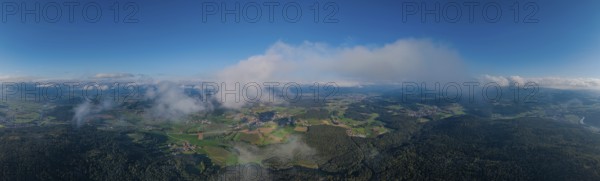 The photo shows a wide landscape with rolling hills and forests under a clear, blue sky. The sun is shining brightly and the clouds are gently drifting by. Roßberg, Miltach, Upper Palatinate