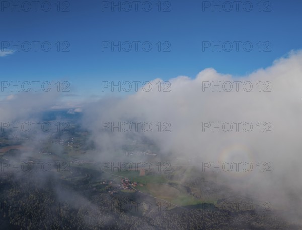 A far-reaching view of Germany's green landscape, surrounded by clouds. The sky is blue and clear. This scenery is peaceful and inviting. Roßberg, Miltach, Upper Palatinate