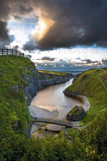 Canyon And Entrance With Bridge To Smoo Cave And Atlantic Coast At Sunset Near Durness In Scotland, United Kingdom