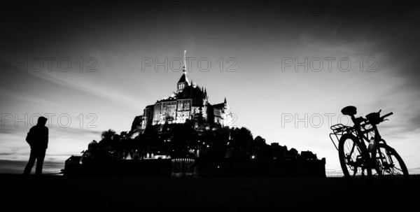 Saint Michel mount in France silhouette with person and bicycle