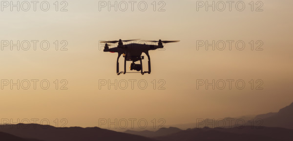Quadcopter in the air with mountains landscape in a countryside of Slovenia
