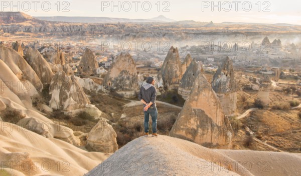 Male person with morning view of Goreme town in Cappadocia. Turkey travel