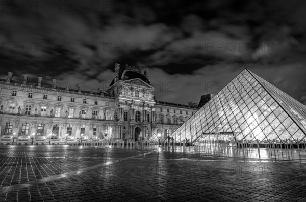 Louvre museum exterior at night in Paris