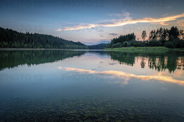 Reflection of clouds and trees in the water at sunset in a calm atmosphere, Zeulenrodaer Meer reservoir, Zeulenroda-Triebes, Thuringia, Germany
