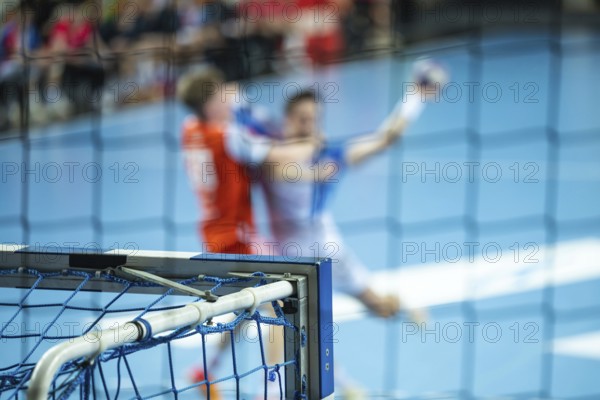 Detail of the handball goal and blurred players in action in the background. Lubin, Poland