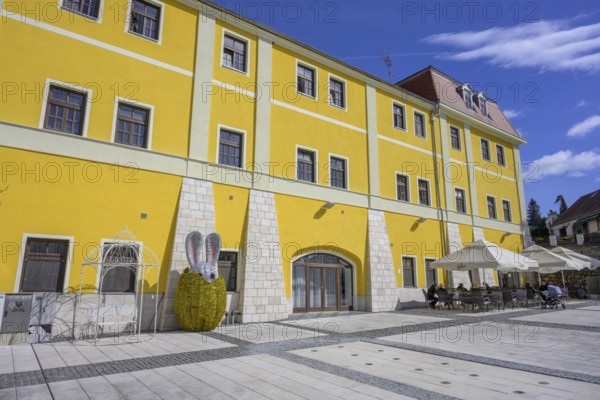 Square in front of old house with café and glittering Easter bunny figure, Varaždinske toplice, Varaždin County, Croatia