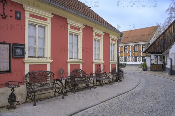 Alley in the old town centre with wrought-iron benches made from old metal parts, Varaždin, Varaždin County, Croatia