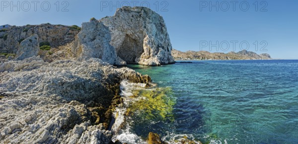 Cave of Archangelos on the coast of Grande Blue with clear blue sea and bright sky in the background, Grande Blue Beach, Stegna, Archangelos, Rhodes Island, Greece