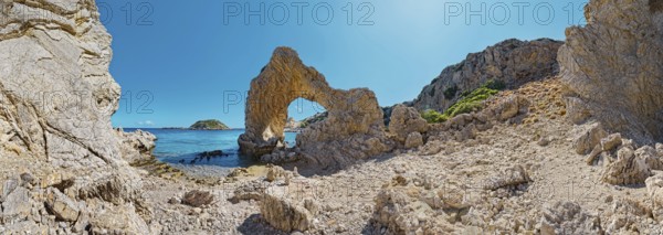 Rocks and rock arches on Grande Blue Beach under a clear blue sky in a sunny coastal landscape, Grande Blue Beach, Stegna, Archangelos, Rhodes Island, Greece