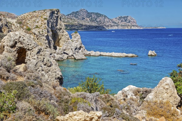 Clear blue coastal landscape Grande Blue with rocky coastline and calm sea under a clear sky, Grande Blue Beach, Stegna, Archangelos, Rhodes Island, Greece