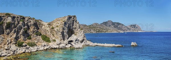 Rocky coastal landscape at Grande Blue Beach with clear blue water and a bright blue sky, Grande Blue Beach, Stegna, Archangelos, Rhodes Island, Greece
