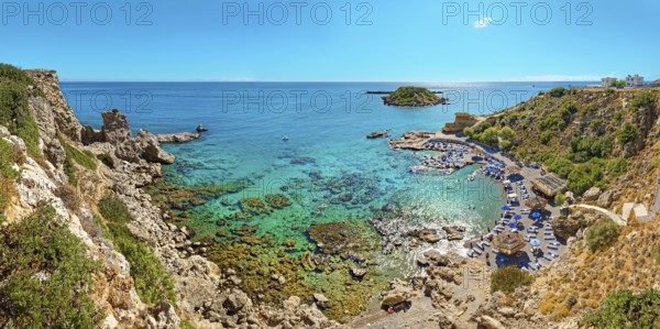 Grande Blue Bay with clear, turquoise-coloured water and rocks in sunny weather, Grande Blue Beach, Stegna, Archangelos, Rhodes Island, Greece