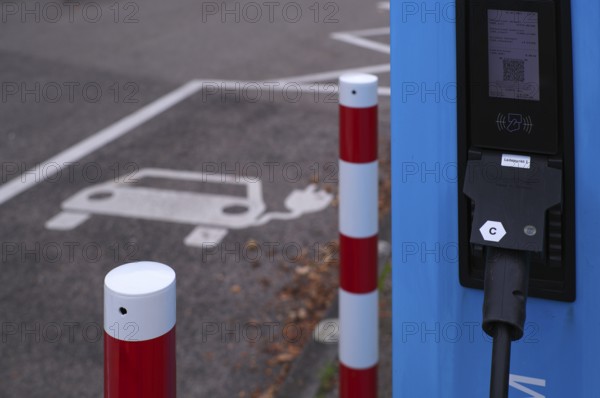 Car park with petrol pump, EnBW charging station for electric cars, electric filling station, e-filling station, e-mobility, empty, free, unused, without e-car, pictogram, logo, Stuttgart, Baden-Württemberg, Germany