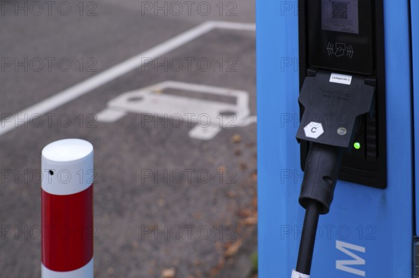 Car park with petrol pump, EnBW charging station for electric cars, electric filling station, e-filling station, e-mobility, charging light, green, empty, free, unused, without e-car, pictogram, logo, Stuttgart, Baden-Württemberg, Germany