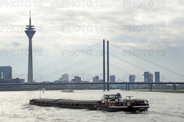 Inland navigation in front of the Rheinkniebrücke, behind it the Rheinturm, TV tower, Düsseldorf, Rhineland, North Rhine-Westphalia, North Rhine-Westphalia, Germany