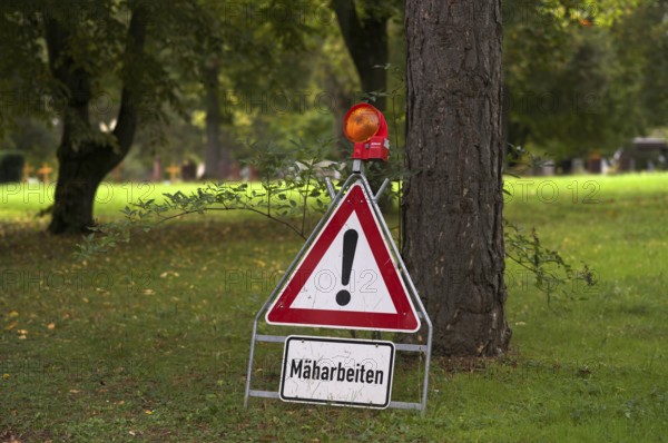 Sign, warning sign, mowing work, main cemetery, Stuttgart, Baden-Württemberg, Germany