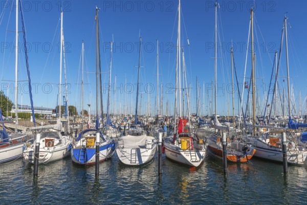 Strande marina near Kiel, Rendsburg-Eckernförde district, ship masts, water reflection, dolphins, Baltic Sea, sailing, leisure activities, water sports, summer, blue sky, sunshine, Bay of Kiel, Schleswig-Holstein, Germany