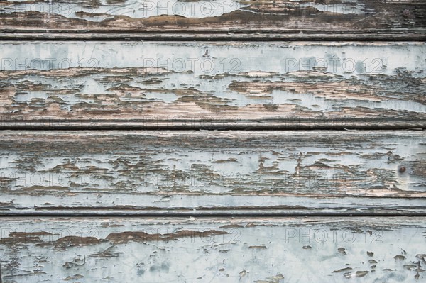 Old wooden door with peeling paint, texture, background, Germany
