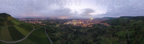 Dusk over an illuminated town, surrounded by vineyards and orchards, Korb and Kleinheppach in the Rems Valley, Baden-Württemberg, Germany