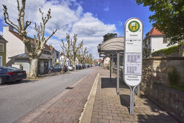 Bus stop Graben, bus shelter, public transport, public transport, street, multi-family houses, parking boxes, cars, street, blue sky, cumulus clouds, street Graben, Heppenheim, Odenwald, Bergstraße district, Hesse, Germany