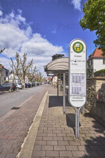 Bus stop Graben, bus shelter, public transport, public transport, street, multi-family houses, parking boxes, cars, street, blue sky, cumulus clouds, street Graben, Heppenheim, Odenwald, Bergstraße district, Hesse, Germany