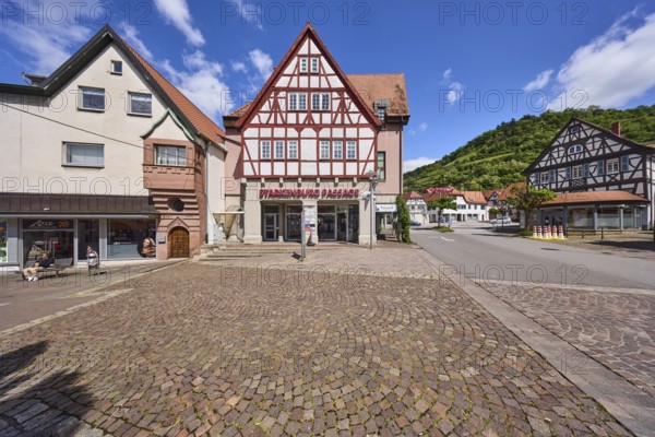 Starkenburg Passage, Schlossberg, pedestrian zone, shopping centre, hill, half-timbered houses, general architecture, shopping, cobblestones, trees, forest, blue sky, cumulus clouds, intersection Friedrichstraße with Graben and Kleiner Markt, Heppenheim, Odenwald, Bergstraße district, Hesse, Germany