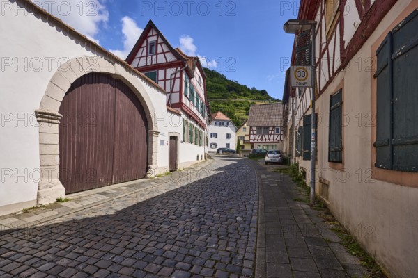Old town, alley, cobblestone pavement, historic half-timbered houses, wall, access gate, blue sky, cumulus clouds, Starkenburgweg, Heppenheim, Odenwald, Bergstrasse district, Hesse, Germany