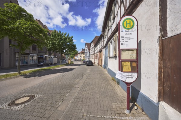 Bus stop Lehrstraße, half-timbered houses, general architecture, street, trees, car park with vehicles, blue sky, cumulus clouds, federal road B460, Lehrstraße, Heppenheim, Odenwald, Bergstraße district, Hesse, Germany