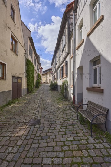 Old town, alley, cobblestone pavement, historic half-timbered houses, historic buildings, facades with windows, bench, shady, blue sky, cumulus clouds, Kleine Bach, Heppenheim, Odenwald, Bergstrasse district, Hesse, Germany