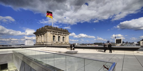 Roof terrace with a German flag in the wind on one of the corner towers of the Reichstag building, government district, Berlin, Germany