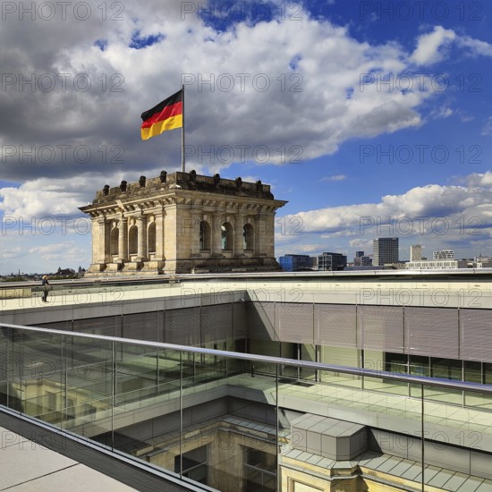 Viewing platform with a German flag in the wind on one of the corner towers of the Reichstag building, government district, Berlin, Germany
