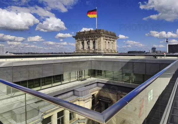 Viewing platform with a German flag in the wind on one of the corner towers and a view of an inner courtyard, government district, Berlin, Germany