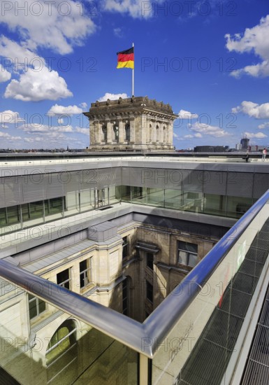 Viewing platform with a German flag in the wind on one of the corner towers and a view of an inner courtyard, government district, Berlin, Germany