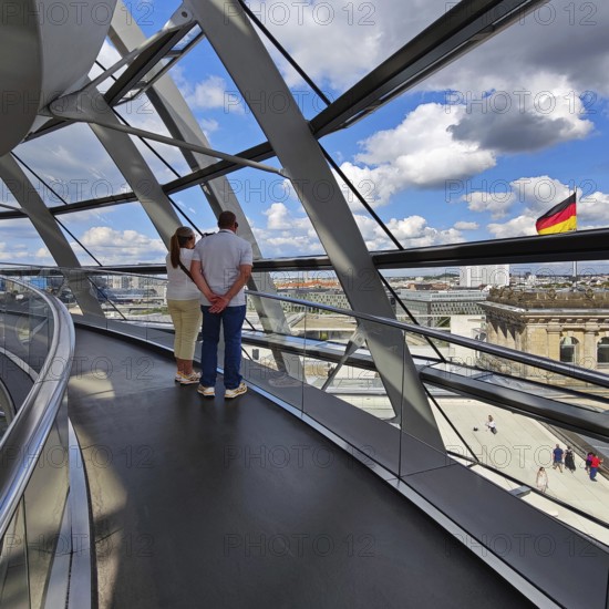 Interior view of the Reichstag dome with visitors and the German flag, Reichstag building, government district, Berlin, Germany