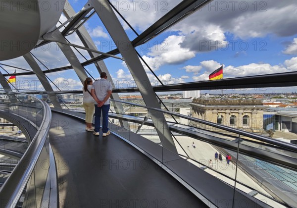 Interior view of the Reichstag dome with visitors and German flags, Reichstag building, government district, Berlin, Germany