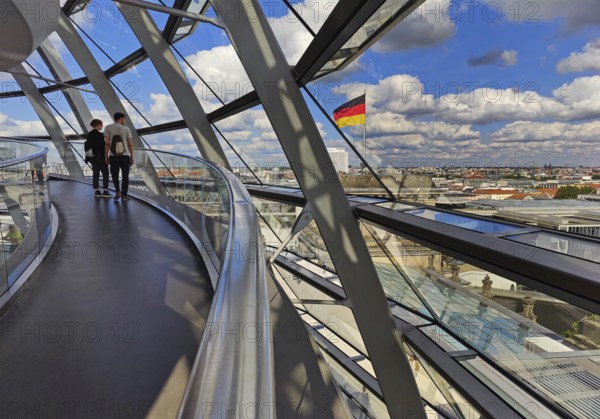 Interior view of the Reichstag dome with visitors and the German flag, Reichstag building, government district, Berlin, Germany