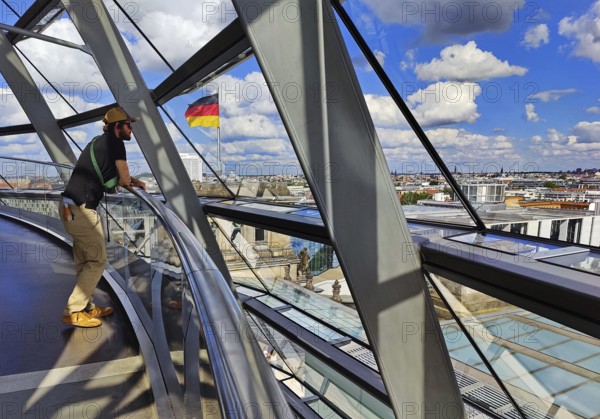 Interior view of the Reichstag dome with visitors and the German flag, Reichstag building, government district, Berlin, Germany