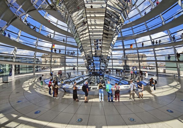 Interior view of the Reichstag dome with the mirror cone and visitors, Reichstag building, government district, Berlin, Germany