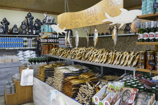 Various products and fish are arranged in a decorative market stall, fish sale, Tsovagyugh, Lake Sevan, Gegharkunik province, Armenia
