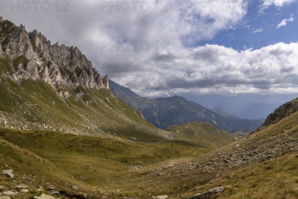 View from Passo del Sole towards Lukmanier and Blenio Valley, on the left steep rock faces at Campanítt, Pizz di Colómb, Olivone, Ticino, Switzerland